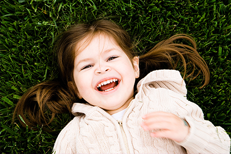 Laughing little girl outdoors